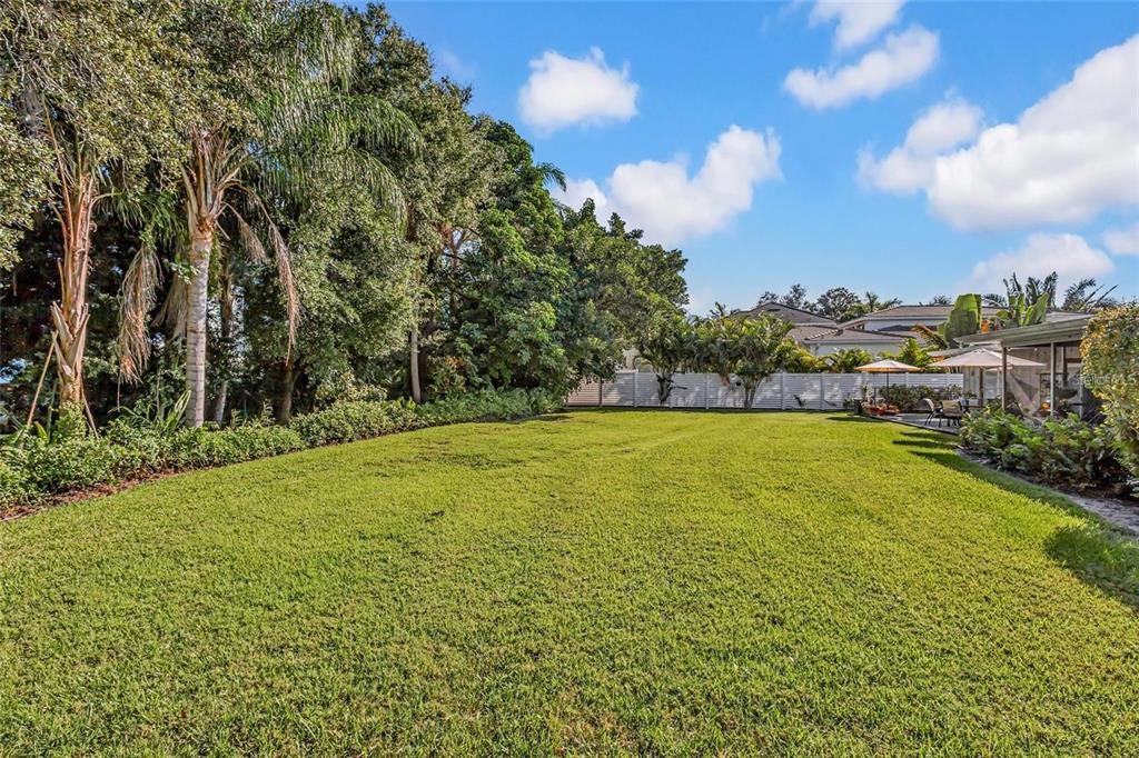 Design a backyard retreat with expansive outdoor living space, lush landscaping, and the privacy of your own secluded oasis.