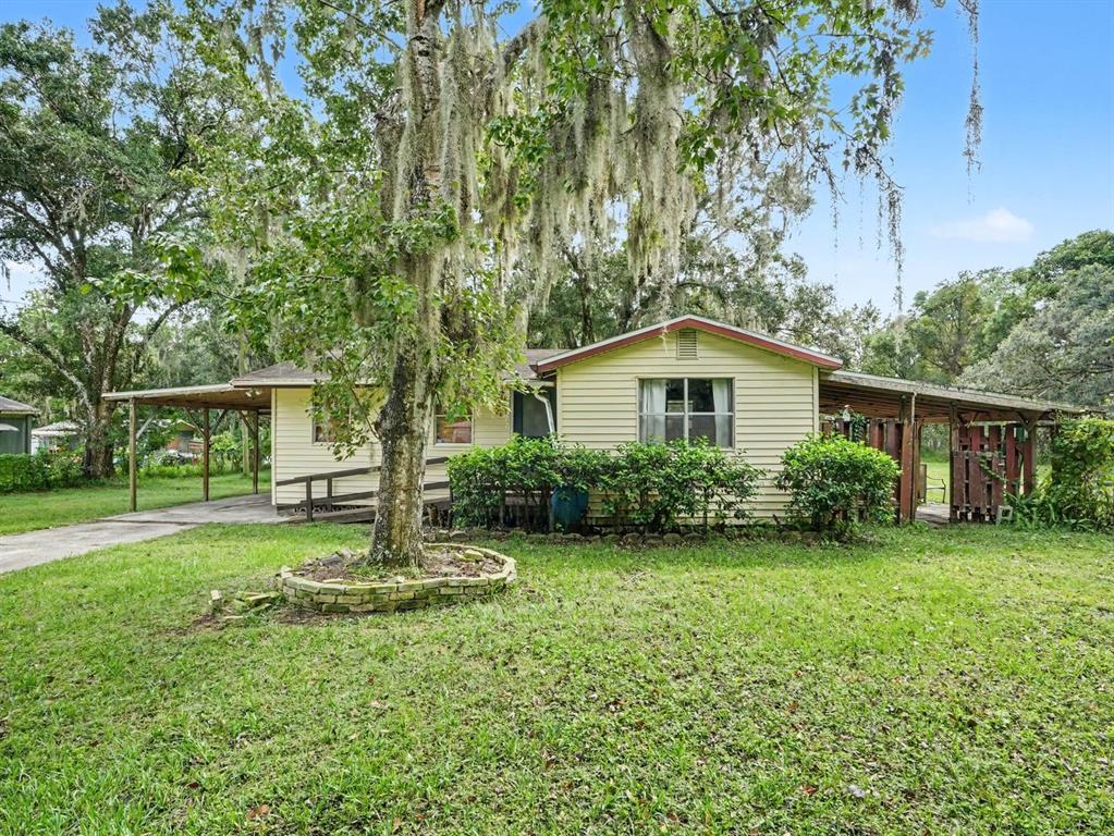 Mature Oak Trees Frame This Cozy Single-Wide Residence