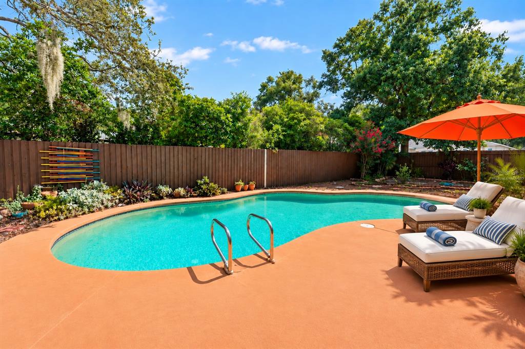 Virtually Staged. Resort-Style Backyard offers a pool, multiple seating areas, and a covered outdoor kitchen!