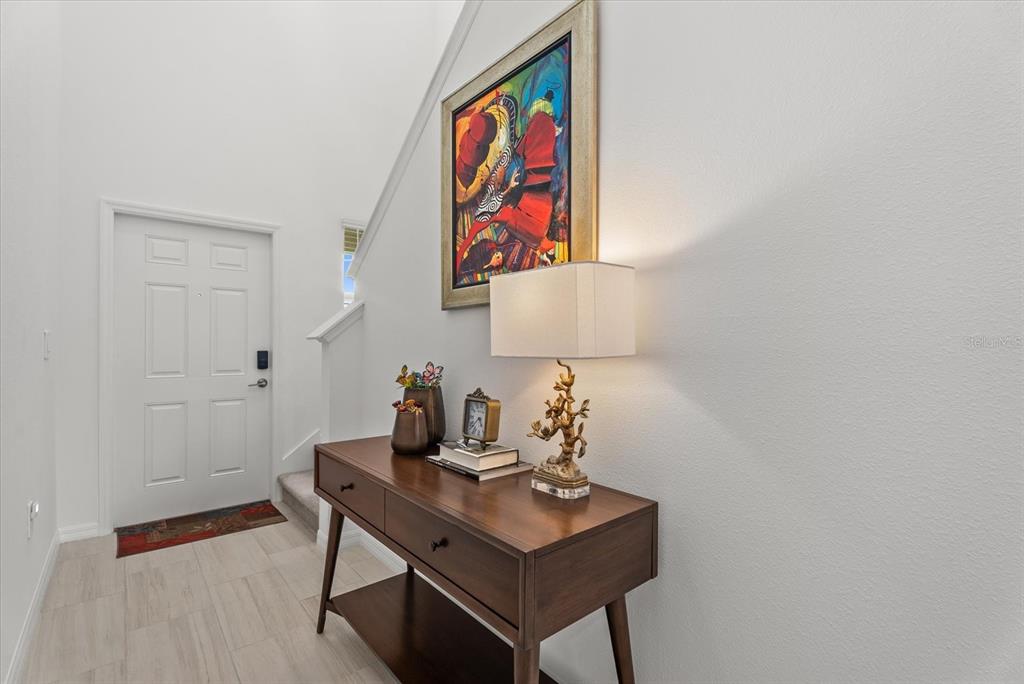 Welcoming foyer with tile flooring and a bright, neutral interior.