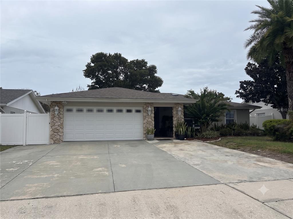 Front of home with extra wide driveway