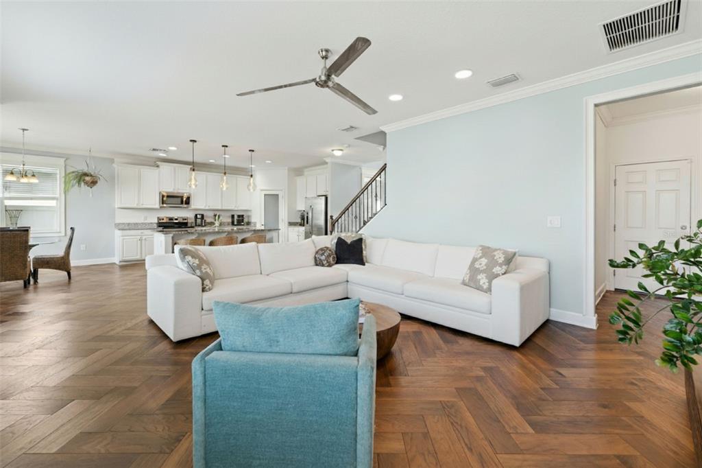 Living area, herringbone wood floors throughout