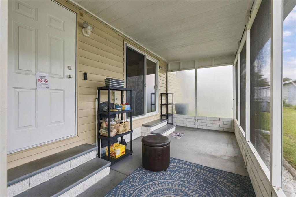 Screened in lanai entrance with sliding glass doors that also access the kitchen