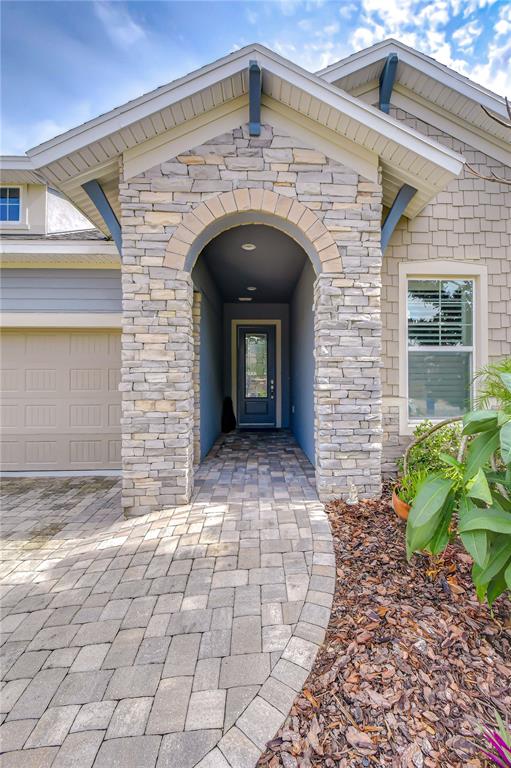 Welcoming covered entry leading into a bright, open-concept floor plan.