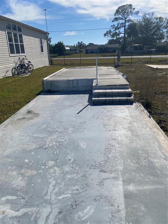 Carport with concrete pad/ steps