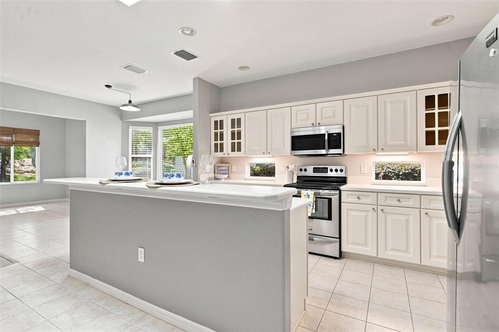 Kitchen features stainless steel appliances, a center island, and overlooks the Family Room, Dinette, and Bonus Room