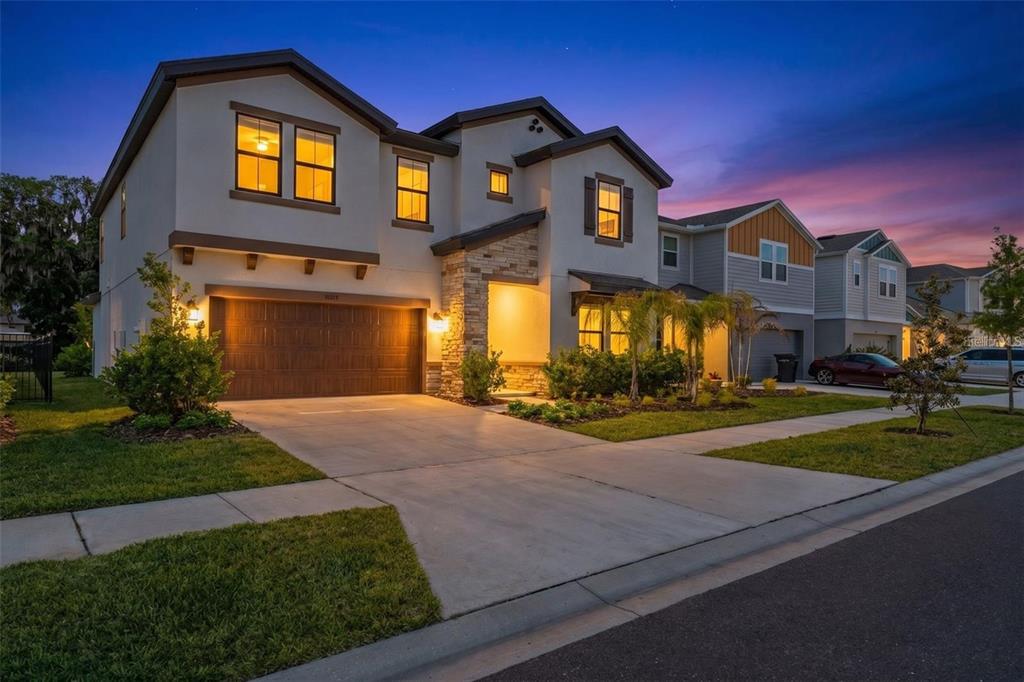 2024 concrete block home with stone accents and a 2-car garage