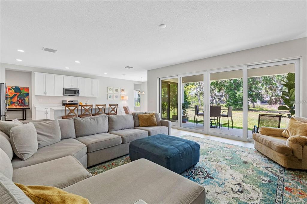 Open great room with a 16-foot sliding glass door to the covered lanai