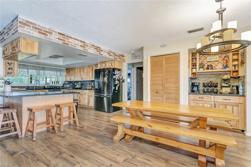 Gorgeous kitchen/Dining area with hickory cabinets and a breakfast bar in the dining room
