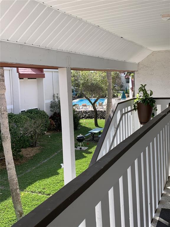 View from front porch with pool only 25 steps to the pool and 3 minutes to the beach.