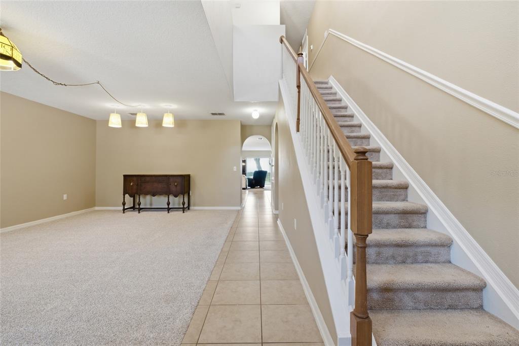 Front entrance into living/ great room with stairs to upstairs