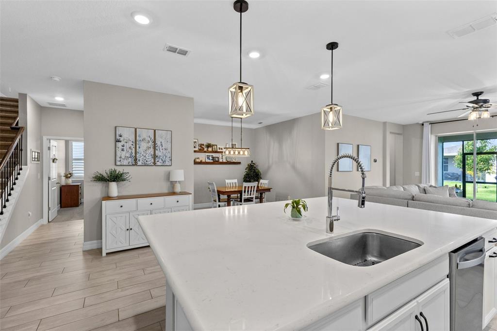 Designer kitchen opens to dining area and family room
