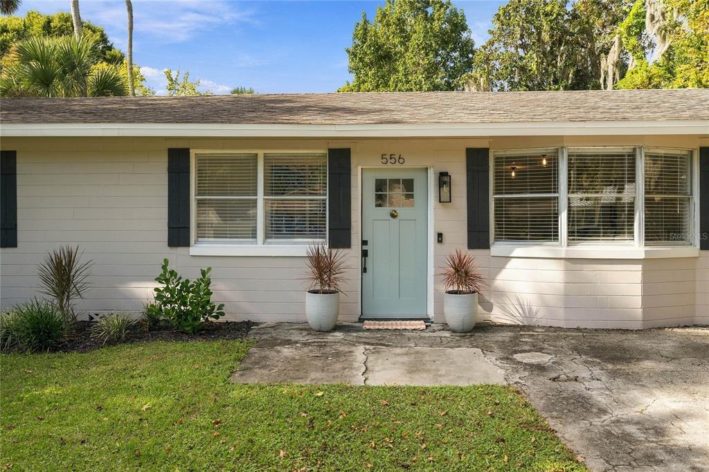 lovely landscaped front and pretty new door and sidelights