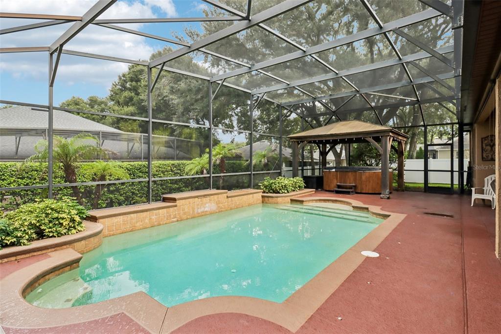 The private screened pool and spa deliver a backyard oasis that is a must see.