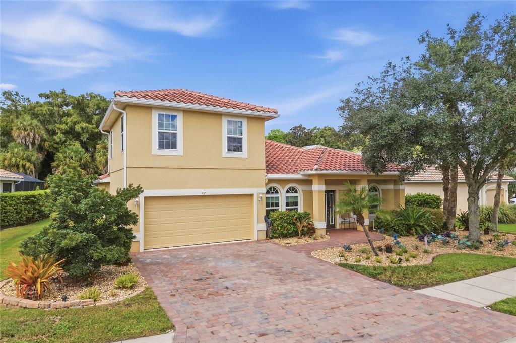 Inviting front exterior featuring mature landscaping and a beautifully maintained entrance.