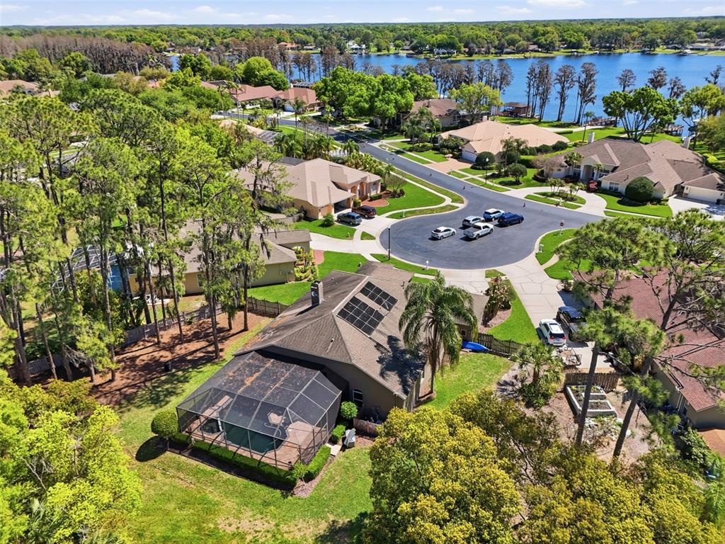Aerial view highlighting the home’s spacious lot, mature surroundings, and close proximity to Lake Padgett