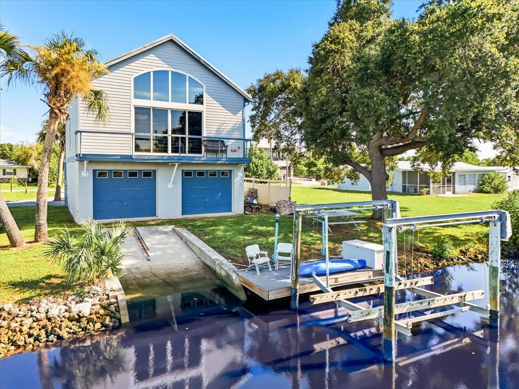 Back of home w/ boat ramp & boat lift