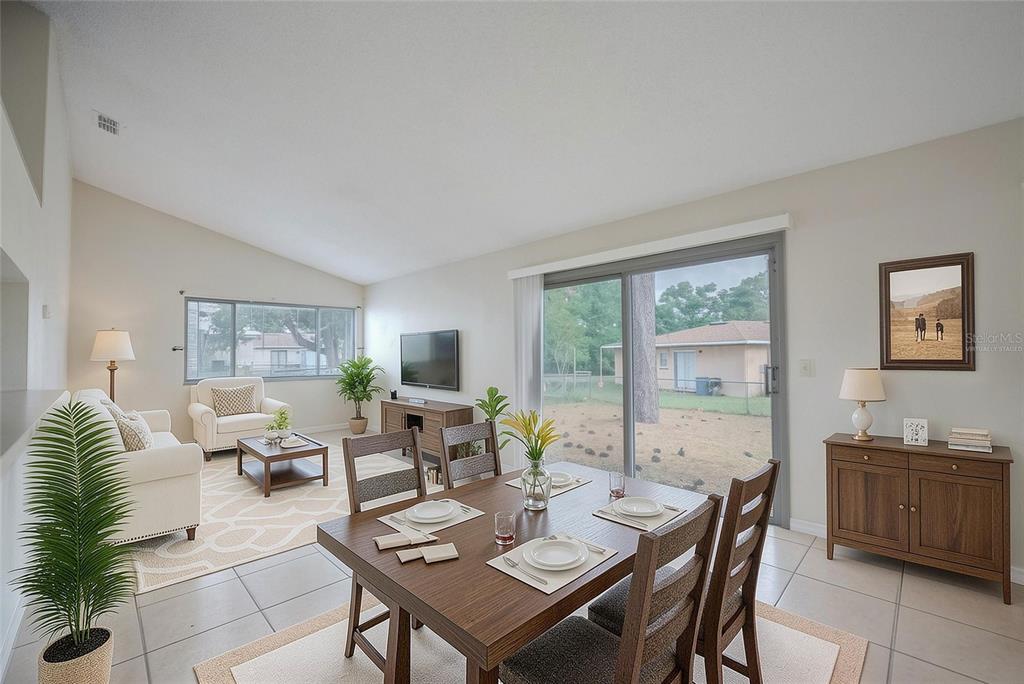 Great room with tile floor and sliding doors to the back yard.  Virtually staged.