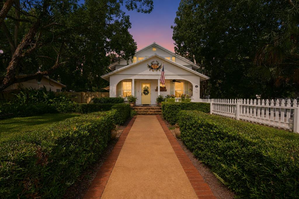 Garden like yard and landscaping. Fenced in front and back.