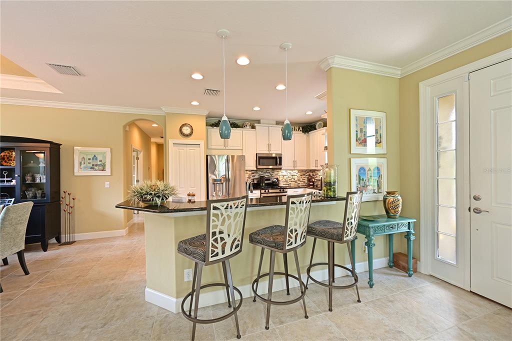 Modern kitchen with white cabinets and solid surface counters