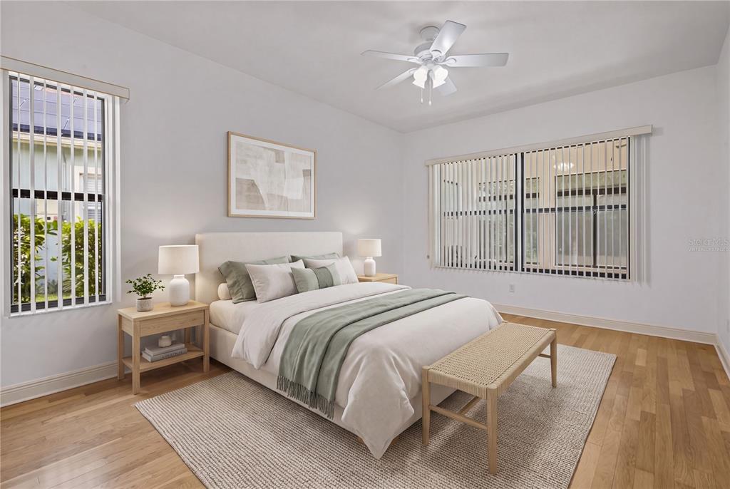 The spacious primary bedroom provides a peaceful retreat en suite bathroom. - virtually staged