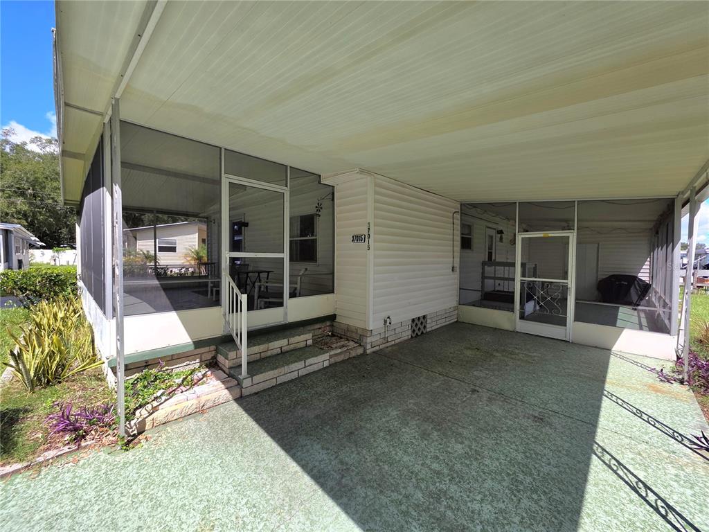 Driveway, carport, raised screen porch, street level screen porch.