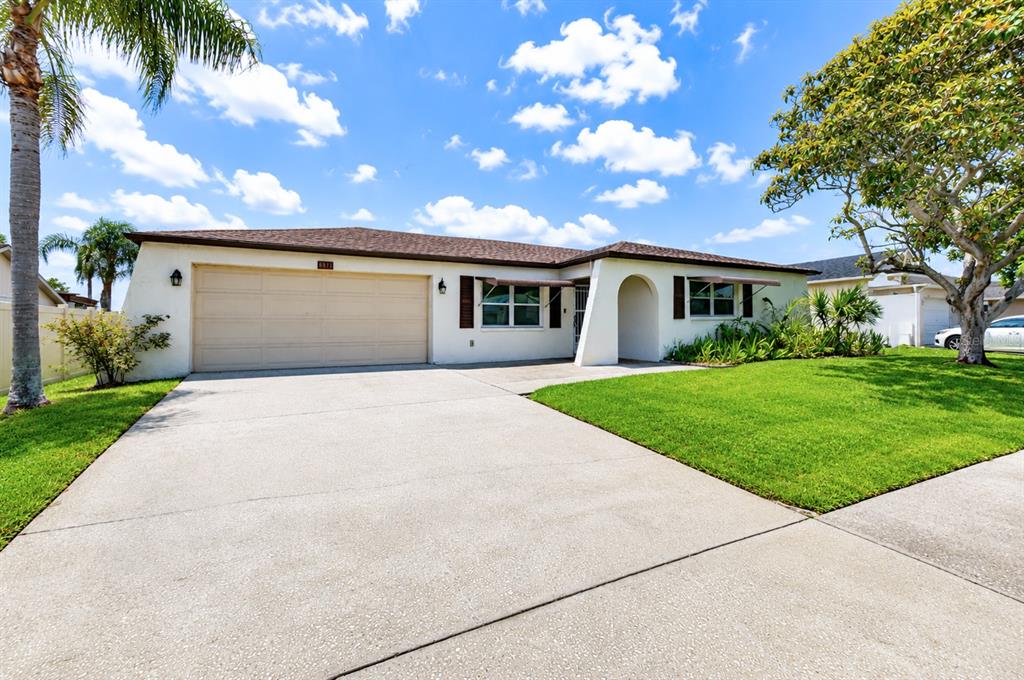 Enjoy a large driveway and private garage with a garage door opener