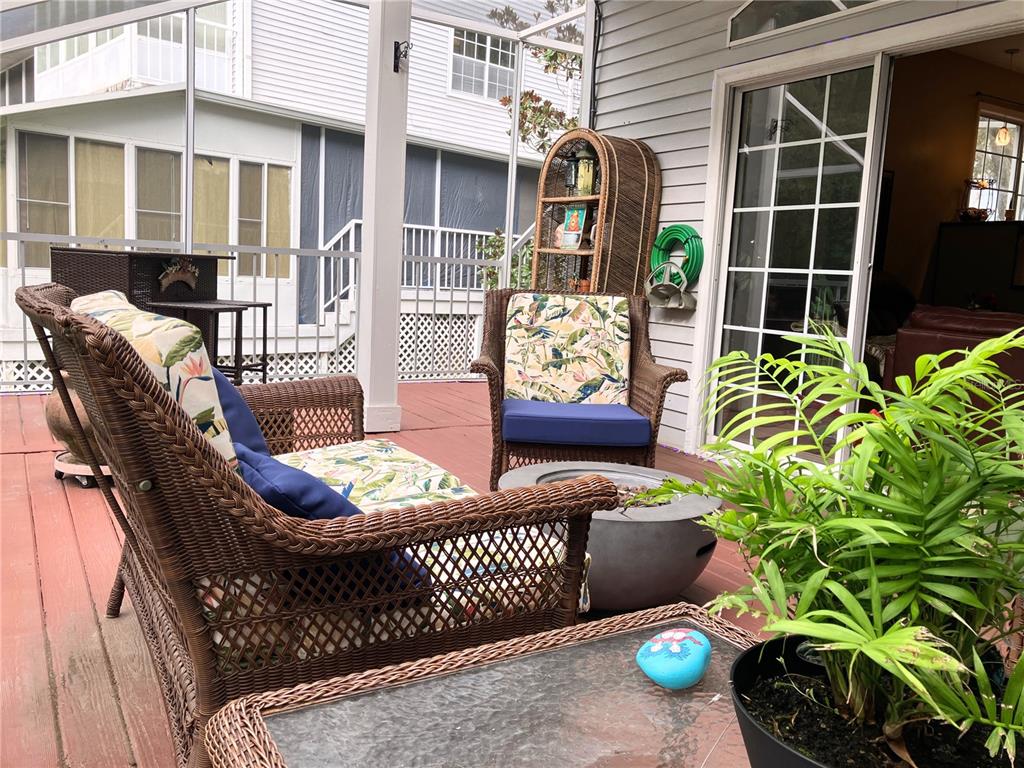 Enclosed back balcony leading to living room and kitchen areas