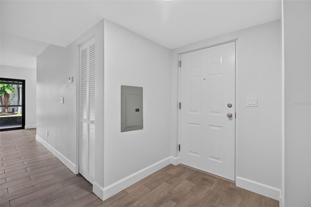 Foyer with new front door and newer electrical panel