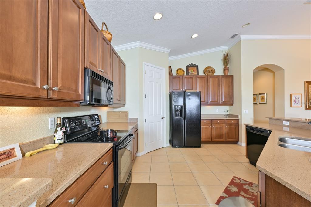 Upgraded kitchen cabinets w/solid surface counters.  Tile flooring throughout and crown molding