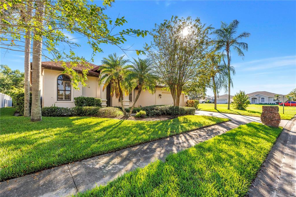 Charming exterior featuring sidewalks, a two-car driveway, and a two-car garage. Located in the beautiful Caya Costa nature preserve, perfect for safe, peaceful strolls at any time of day or night.